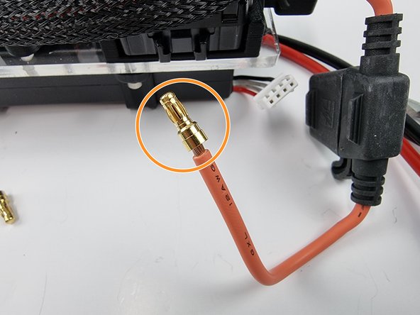 Grab one of the pins from the EC3 connector. The wire from the fuse holder needs to be soldered into the hole in the pin.