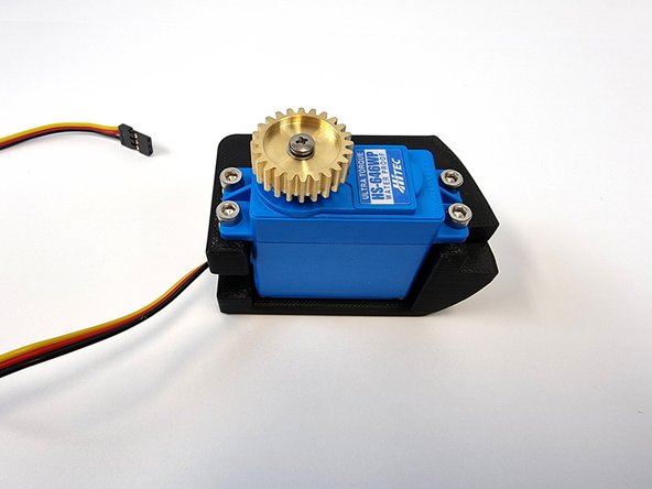 Push the wire through the mount first, followed by the servo.