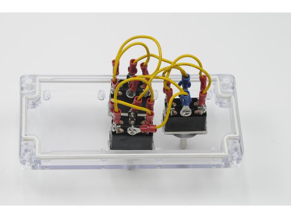 Using the other jumper wire, attach the three ring terminals to the centre post on the right side of each switch.