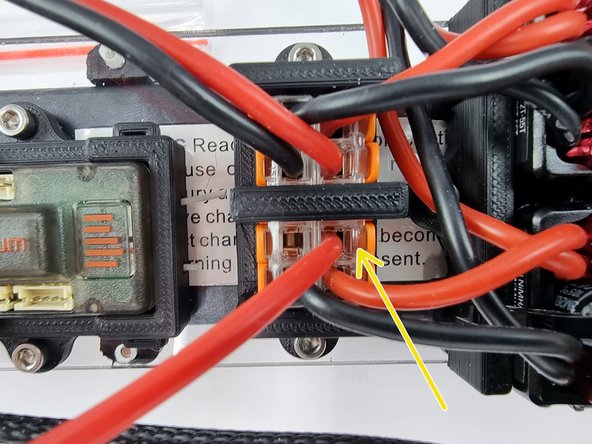 Insert the wire into the Wago 221 connector and lift the lever to lock the wire into place.