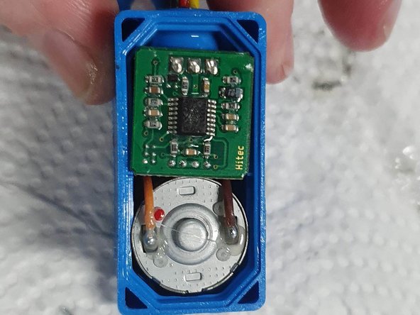 Turn the servo over to show the bottom where the motor and circuit board are.