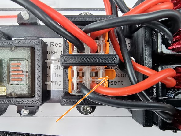 We will insert the end of the wire into the Wago 221 terminal block. Open the lever so that the wire can be inserted.