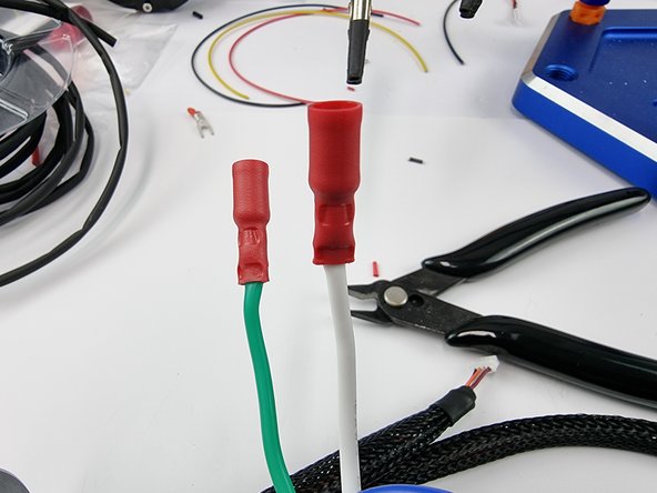 Slide a female bullet connector onto the white wire and crimp it into place. Ensure that you check that it has been crimped on properly.