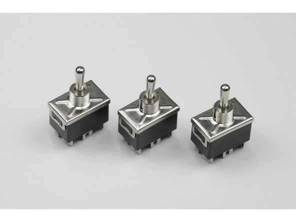 Insert the three switches through the clear plastic faceplate.