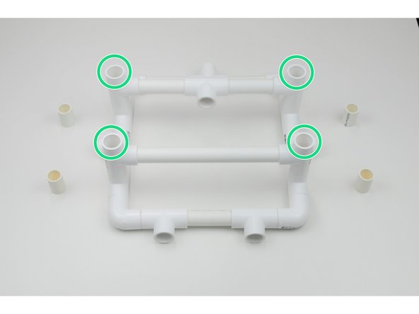 Insert 4 of the 32mm Connectors into the upright Tee Joints of the frame.