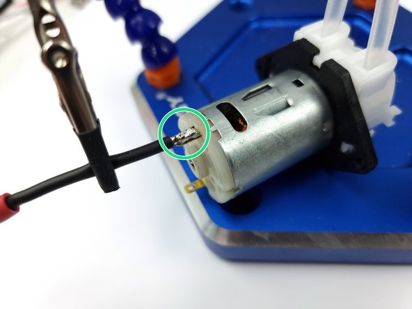 Using a soldering iron add some solder to the wire and also pad of the peristaltic pump.