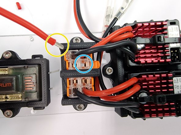 We need to cut the wire to the correct length. We are going to insert it into the vacant spot on the right hand Wago 221 at the top highlighted in blue. Measure out the correct length to allow the wire to reach the bottom of the Wago 221
