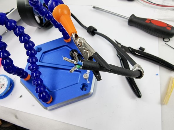 Support the cable to prepare it for soldering.