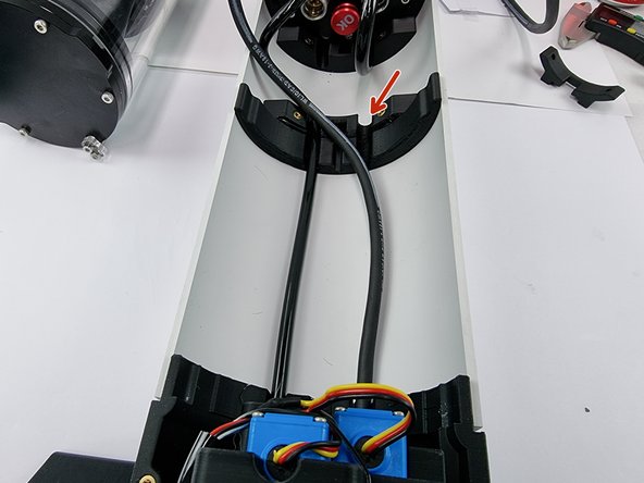 Straighten the cable out and insert it into the slot in the hull support.