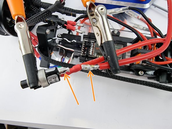 Tin the end of the wire and the pad of the switch with solder to prepare them for soldering.