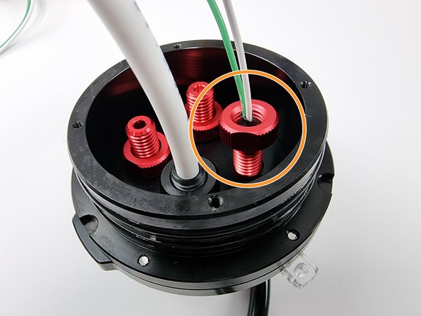 Install the penetrator into the remaining hole of the end cap.