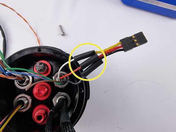 Allow the solder joints to cool then slide the heat shrink over the joints and apply heat to shrink them into place