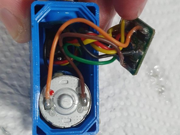 Carefully lift out the circuit board to reveal the space underneath it.