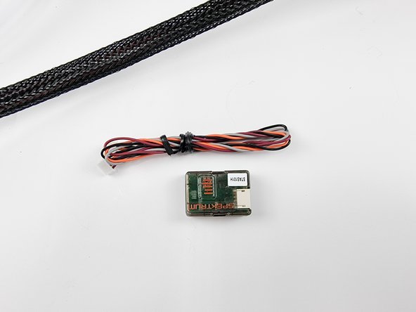 Unbox the satellite receiver. This will be put in the buoy that floats on the water surface to allow the controller to keep radio connection with the submarine. As once the sub submerges under the water surface the radio frequency will no longer be able to get to the receiver in the submarine due to it not being able to penetrate through the water.