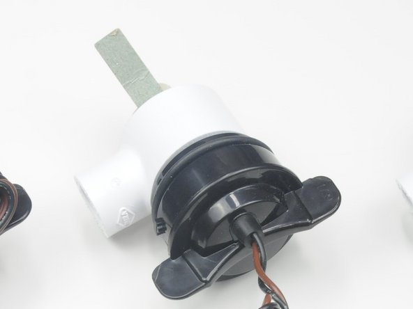 Use the green cardboard (or fold a piece of paper) as a spacer to keep the metal of the adaptor from rubbing on the plastic housing of the motor.