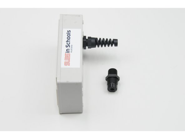 Push the plastic bolt through the hole closest from the centre of the controller.