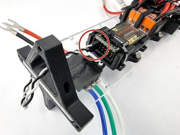 Feed the black and white wire from the thruster ESC through the triangle hole in the support plate mount.