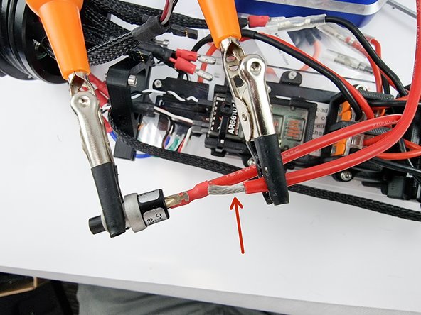 Grab the section of red wire that you have left and strip the insulation from the end of the wire.