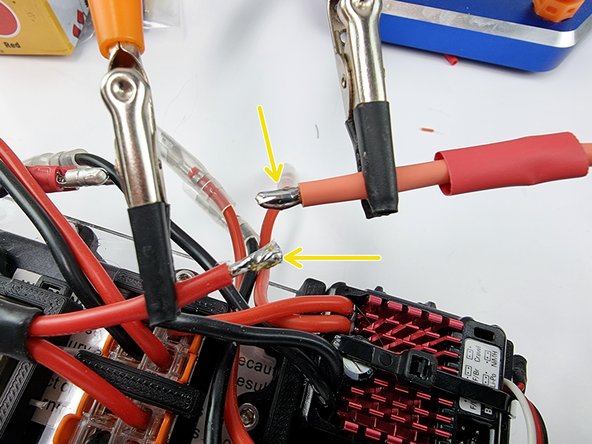 Before soldering the wires cut a section of heat shrink and slide over one of the wires.