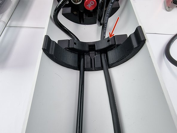 Place a cable cover over the cables in the hull support brace to secure the cables in place.