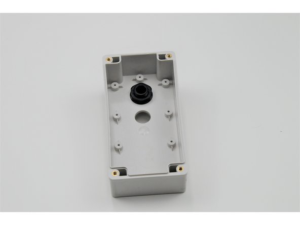 Screw the small nut onto the small threads until the bolt is tightly secured to the control box.