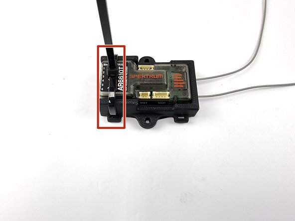 Install a cable tie on the left of the mount using the slot to feed the cable tie through.