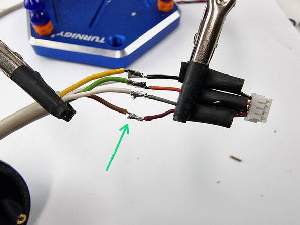Before soldering the wires together slide a strip of heat shrink onto each of the wires.