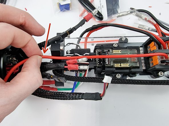 Grab the red wire that was just inserted into the Wago 221 and run it to where the power switch would normally sit to gauge the length at which we need to cut the wire.