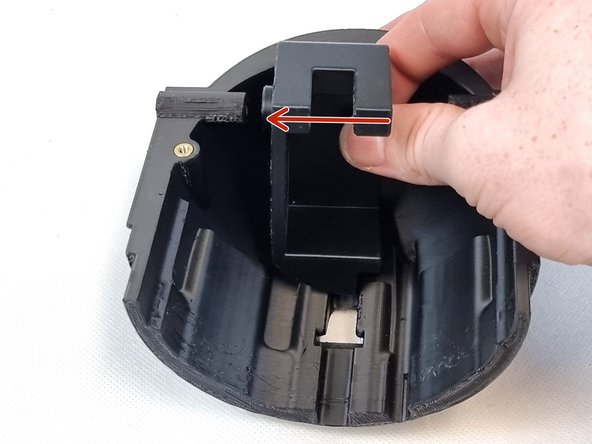 Place the servo  mount into the bottom cap and slide it to the left as shown seating it onto the shaft for the control rod.