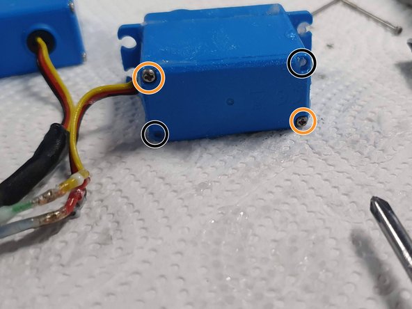 Insert 2 screws in opposite corners and screw them in 90% of the way.