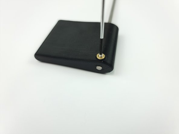 Insert an M3 set screw into the threaded insert and screw it down onto the control rod to fix it in place.