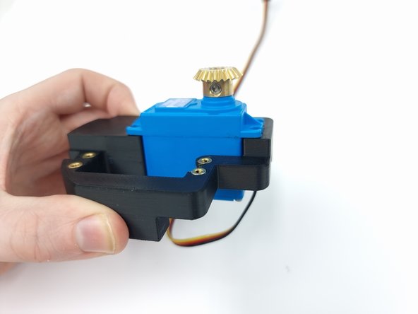 As you push the servo into the mount pull the wire downwards to ensure there is no slack and help it slide the servo into place