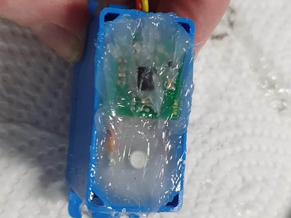 Cover the top of the circuit board and motor with silicone grease
