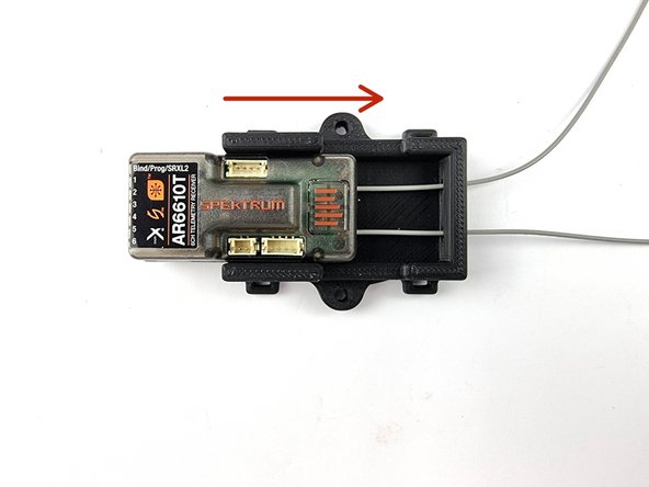 Feed the aerials through the holes in the mount and slide the receiver into the mount