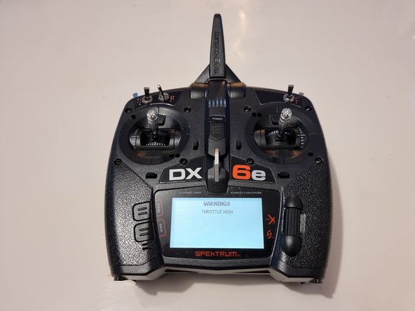 When the controller starts up it will give a warning that the throttle is high. You need to push the throttle joystick down to remove the warning and allow the controller to finish starting up.