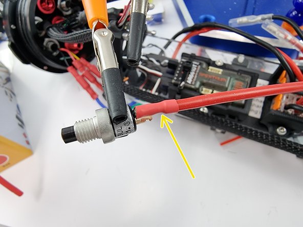 Once the solder has cooled slide the heat shrink over the joint and apply heat to shrink it into place.