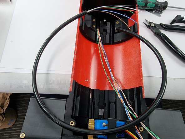 Find the trimmed section of cable from the 6 pin connector. We want to use the cable cover from it to slide over the wires running to the fore servo.