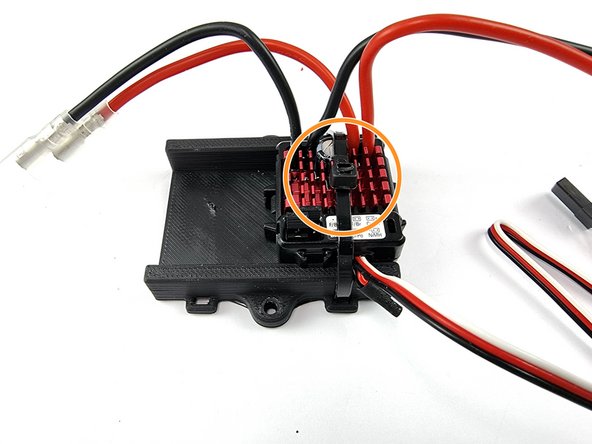 Feed the cable tie through the slot from underneath