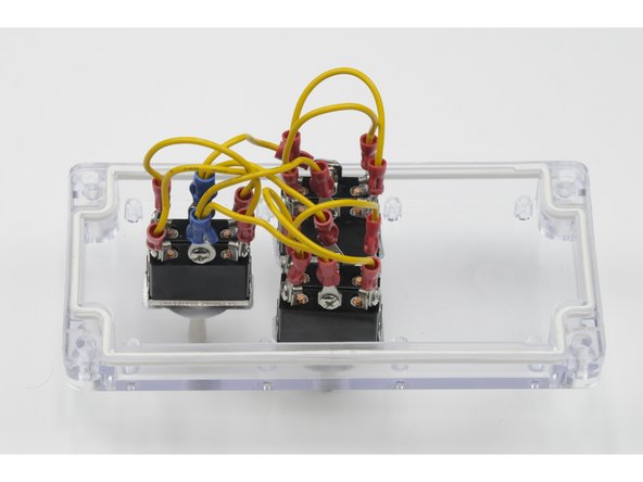 Using the other jumper wire, attach the three ring terminals to the centre post on the right side of each switch.