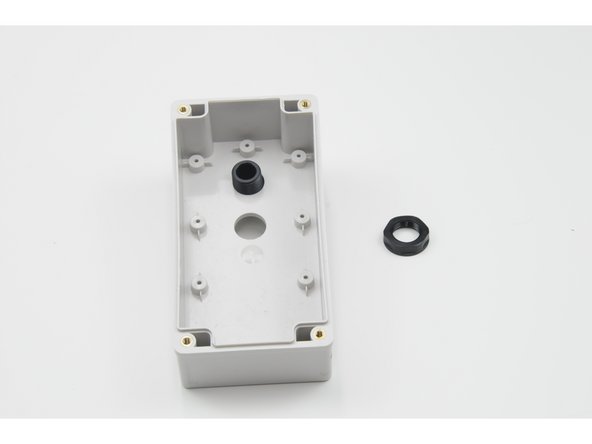 Screw the small nut onto the small threads until the bolt is tightly secured to the control box.