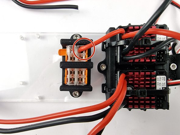 Insert the positive wire into one of the connectors. Ensure it is pushed in all the way and lift up the lever to lock the wire into place.