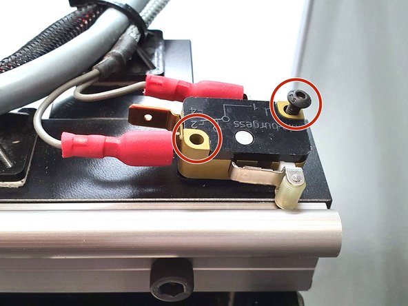 Reinstall the 2 screws that were removed earlier.