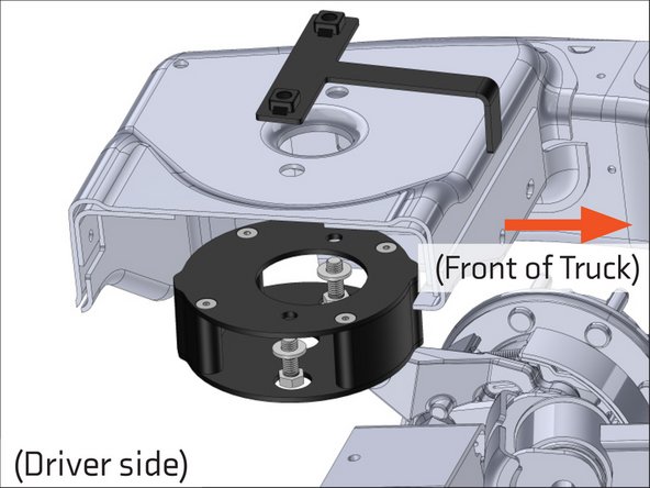 Place the weld nut bracket on top of the crossmember, with the bent tab facing the front of the truck, and line it up with the two holes shown.