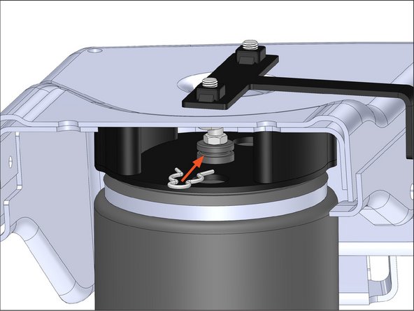Grab the lower part of the air spring assembly and insert the elbow fitting through the center hole on the upper bracket, making sure to not damage the fitting.