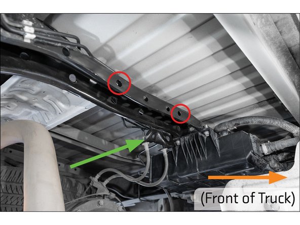The assembly will be mounted through the circled holes in the frame cross-member.