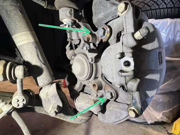 Using 12mm socket, disconnect the brake line  from the caliper and let it drain into the drain pan