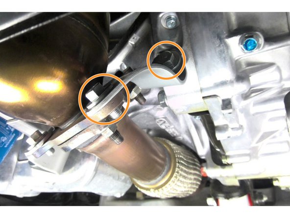Reinstall the four (4) 14mm bolts securing the two lower downpipe support brackets as shown Torque bolts to 33 ft-lbs