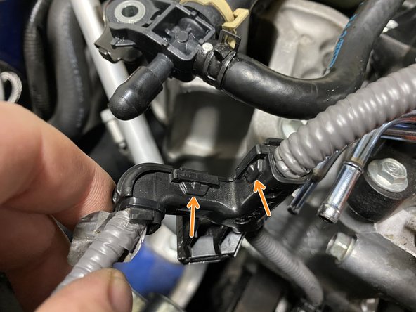 There are five (5) tabs that need to be loosened to remove the cover from the wiring loom
