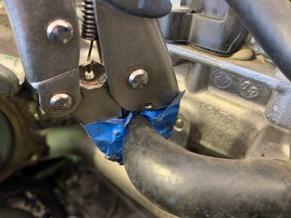 Undo the clamp holding the upper hose to the hard line