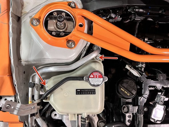 Use 10mm socket, ratchet, and extension to remove (2) 10mm bolts securing the coolant tank to its chassis brackets